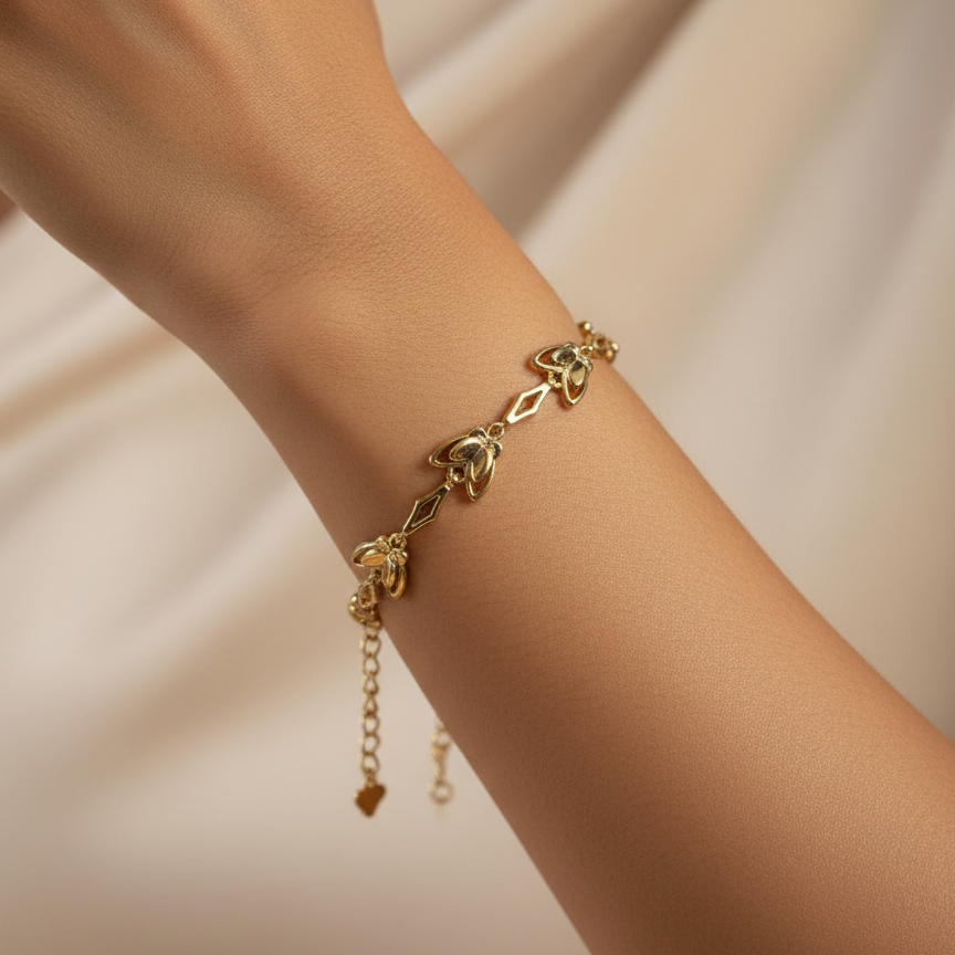 Gold bracelet on a person's wrist with a soft beige background